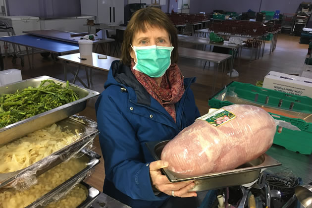 Amanda Simpson poses with food at the Clem Attlee estate hall