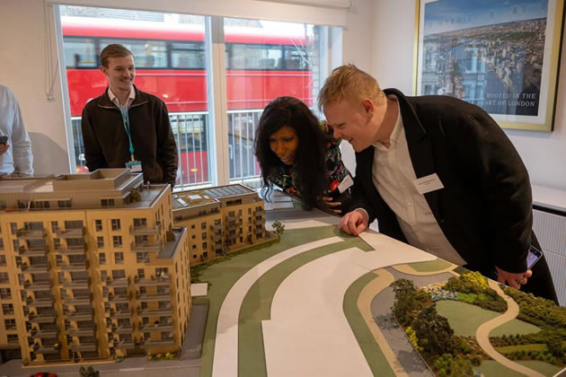 Cllr Umeh looks at a model of the development with Adam and Oscar from Peabody Housing Association