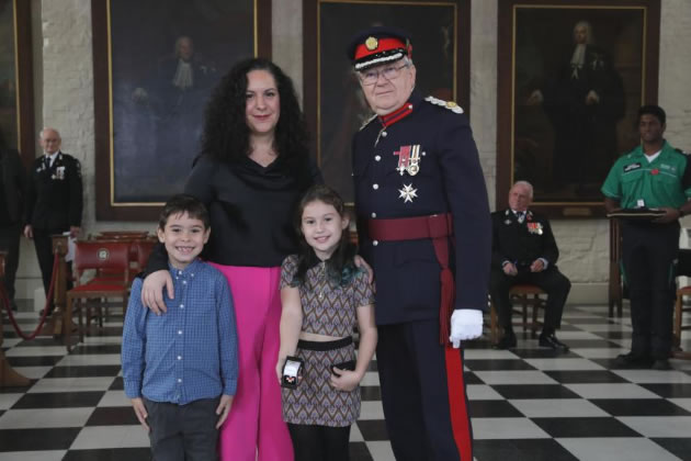Chris Streat's widow Maria and the couple’s two children, Rosalita and Santino, accepting the Order of St John on his behalf