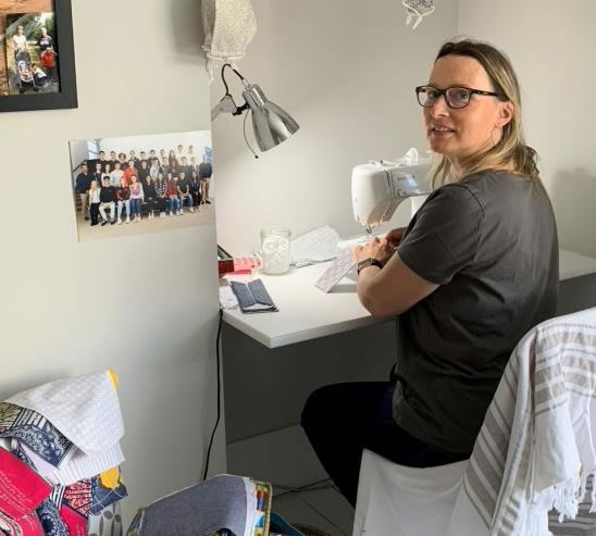 Dorothée d’Argentré working at her desk on her sewing machine