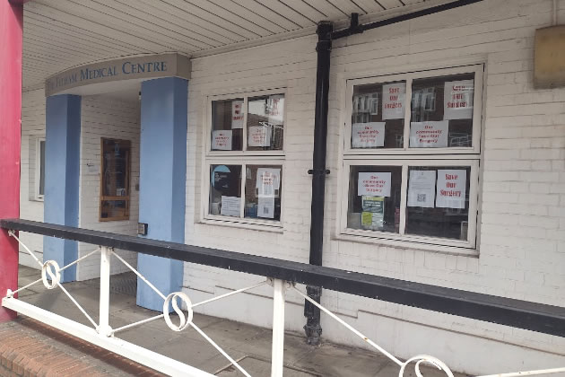 Fulham Medical Centre with posters in the windows