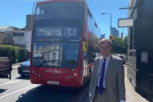 Greg Hands in front of a C3 bus