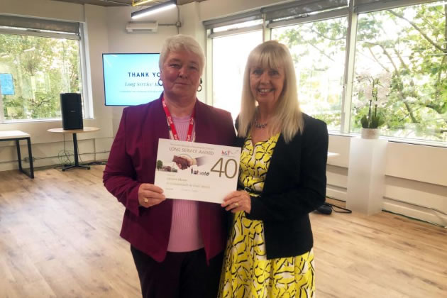 Lorraine Mason (left) receiving a long service award from Sharon Lea (right), Chief Executive of H&F Council