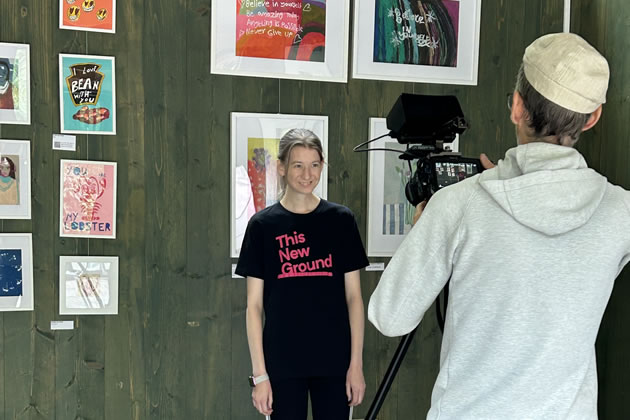 Artist Kelly with her print of her cat Andre which features in This New Ground’s new film