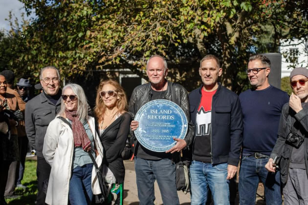 Mark Marot (centre), managing director of Island Records from 1982 to 2000, holding the plaque