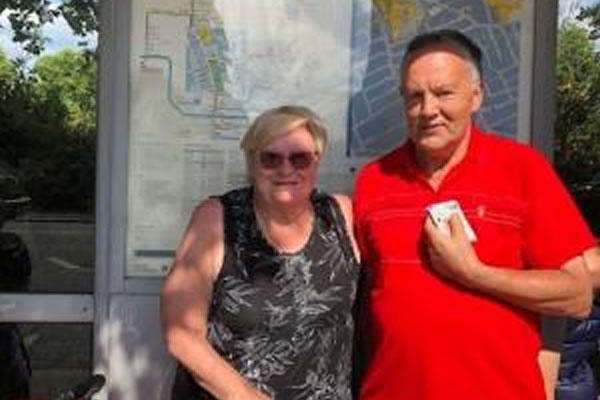 Mr and Mrs Young at a 74 bus stop on Lillie Road